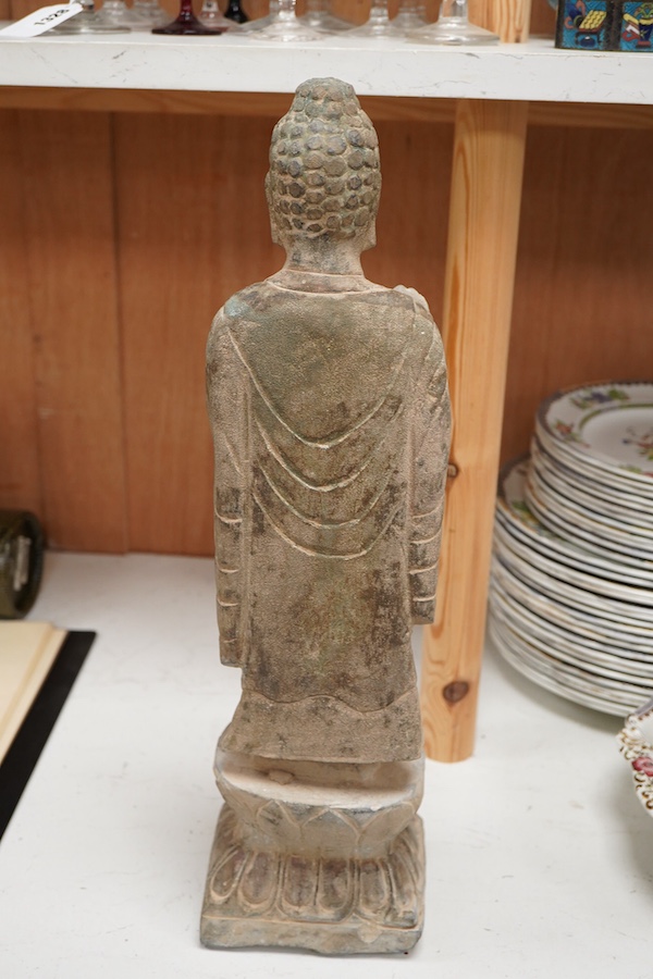 A Chinese composition stone standing figure of Buddha, 48cm high